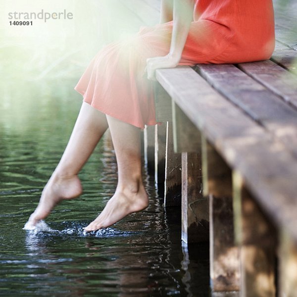 Junge Frau am Fluss sitzend