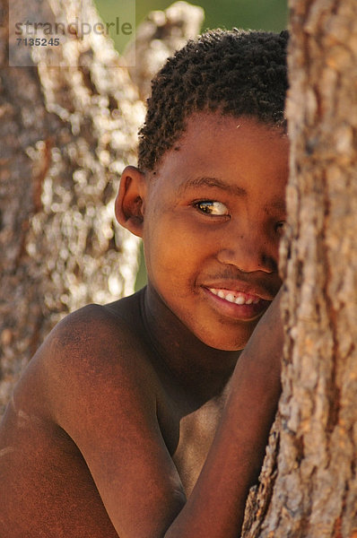Hochformat , Portrait , Landschaft , verstecken , lächeln , Junge - Person , Namibia , Jagd , primitiv , Afrika , Nomade , Volksstamm,  Stamm