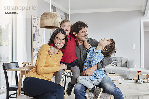Porträt einer glücklichen Familie mit zwei Kindern zu Hause