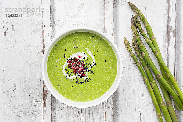 Green asparagus soup with pomegranate seeds and black sesame