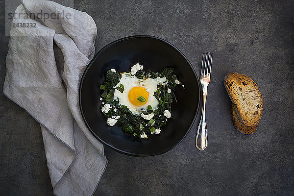Green Shakshouka with baby spinat,  chard,  spring onions and basil in bowl