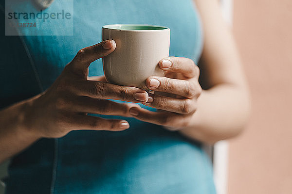 Woman holding cup of coffee,  close up