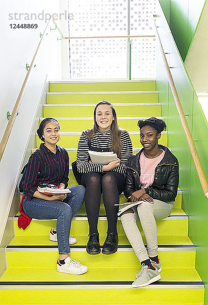 Portrait smiling,  confident high school girls sitting on stairs