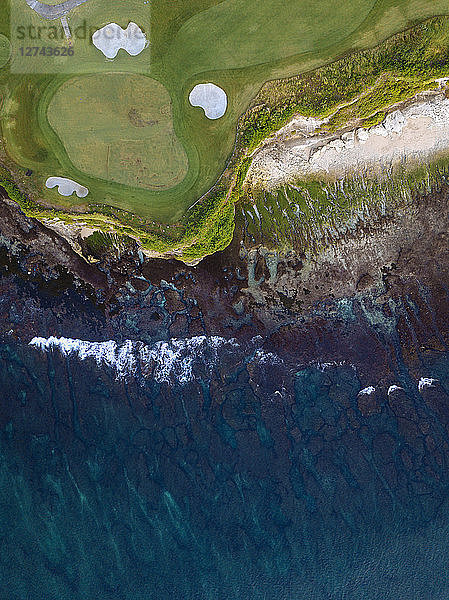 Indonesia,  Bali,  Aerial view of golf course with bunker and green at coast