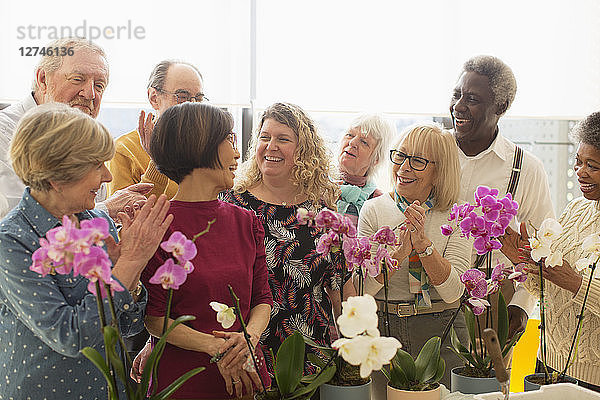 Happy active seniors enjoying flower arranging class