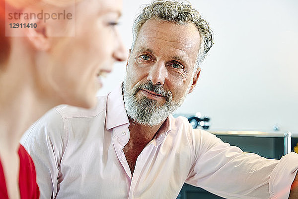Mature man looking at female colleague in office