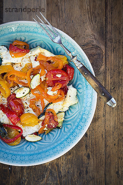 Baked goat cheese with paprika,  tomato and zucchini