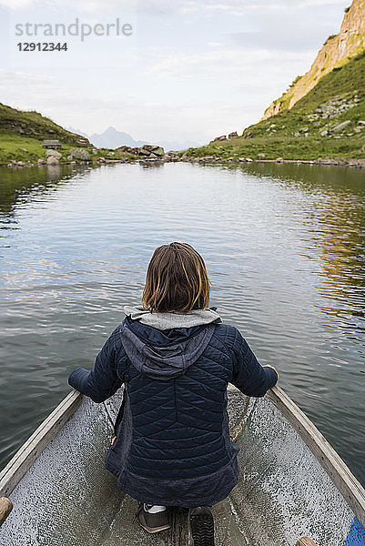 Austria,  Tyrol,  Fieberbrunn,  Wildseeloder,  woman in a boat on lake Wildsee