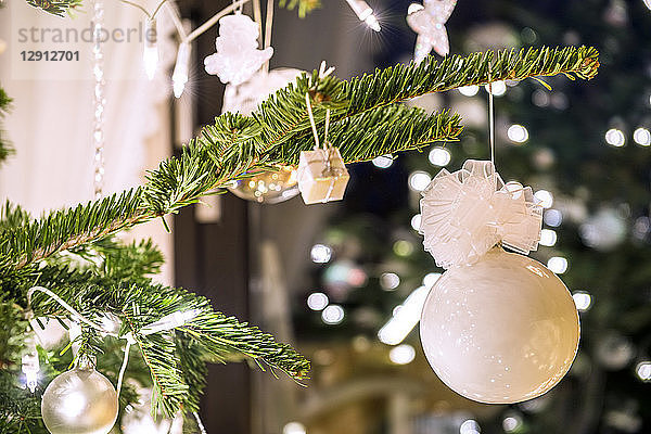 Fir branch with white Christmas decoration