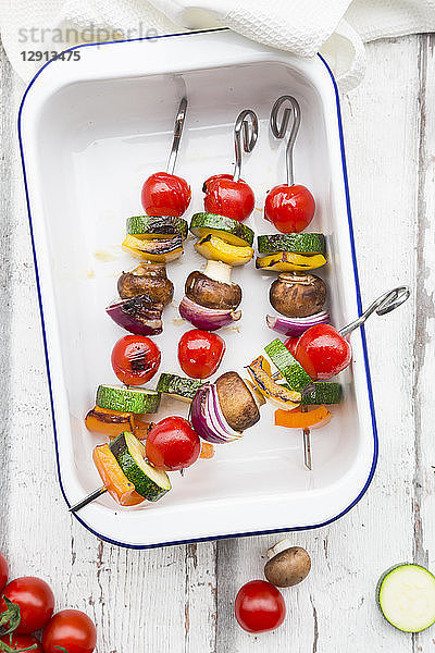 Vegetarian grill spits,  orange and yellow paprika,  tomato,  red onion,  zucchini and champignons