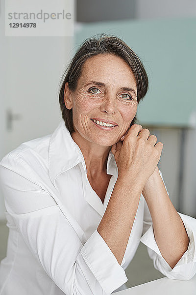 Portrait of mature businesswoman wearing white blouse