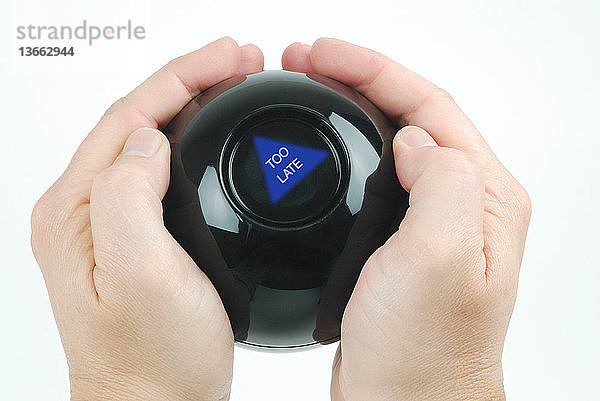 Hands holding a magic eight ball that says,  too late.