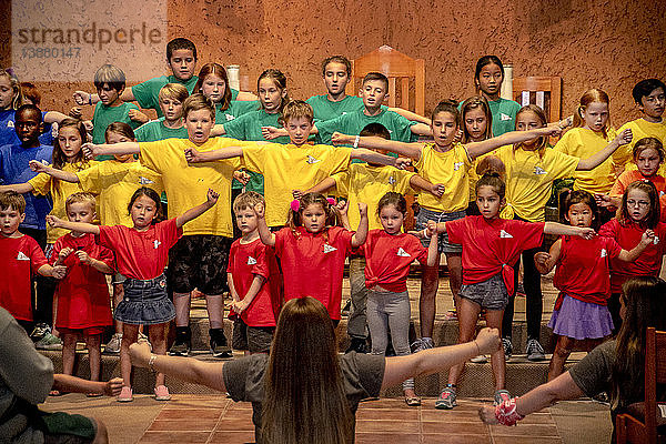 Children follow a director's instructions as they rehearse for a Christmas entertainment