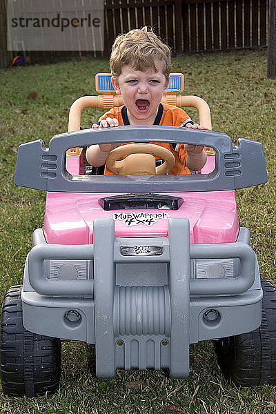 Boy in Toy Car