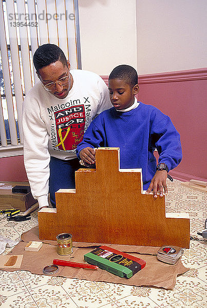 African American father and son doing crafts