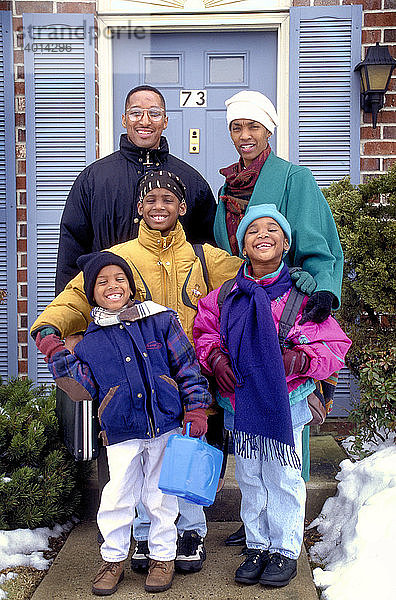 African American family outside their home