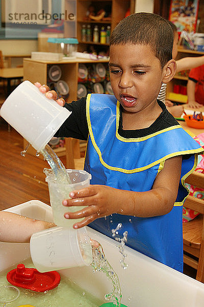 Child Plays with Water in Day Care