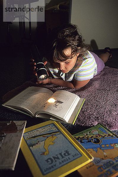 Girl Reading by Flashlight