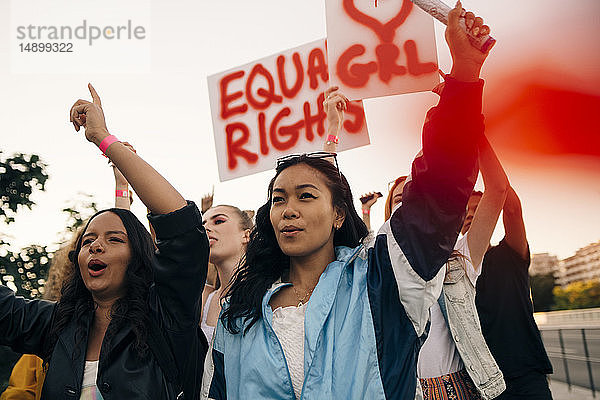 Frauen mit Transparenten,  die gemeinsam für gleiche Rechte gegen den Himmel protestieren