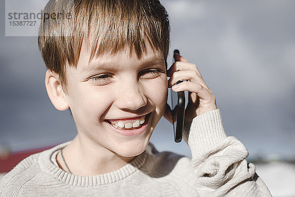 Porträt eines glücklichen Jungen am Handy