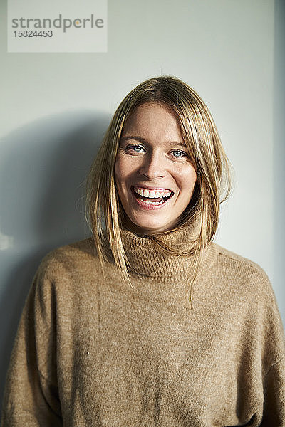Porträt einer lachenden blonden jungen Frau