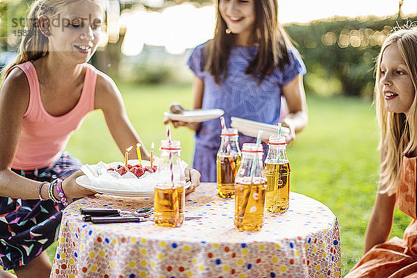 Glückliche Mädchen feiern Geburtstag im Freien