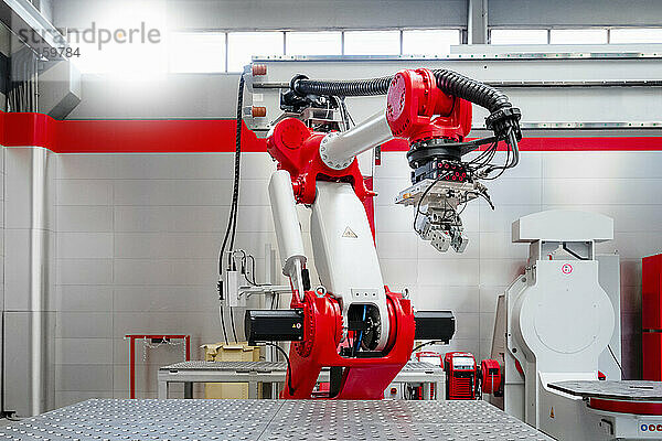 Rot-weißer automatischer Schweißroboter in einer Fabrik