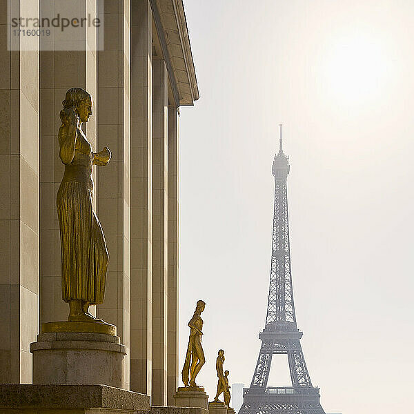 Frankreich,  Ile-de-France,  Paris,  Goldene Statuen des Palais de Chaillot mit Eiffelturm im Hintergrund