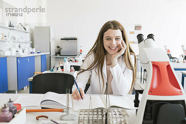 Porträt eines jungen Forschers im weißen Kittel in einer wissenschaftlichen Klasse