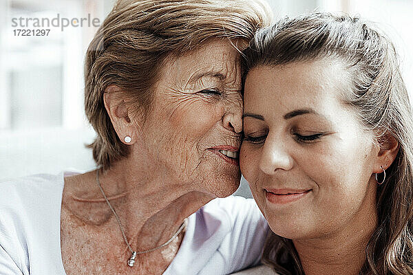 Zärtliche Großmutter mit Enkelin zu Hause